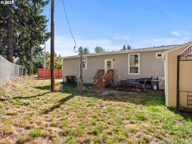 a view of a backyard with a large tree