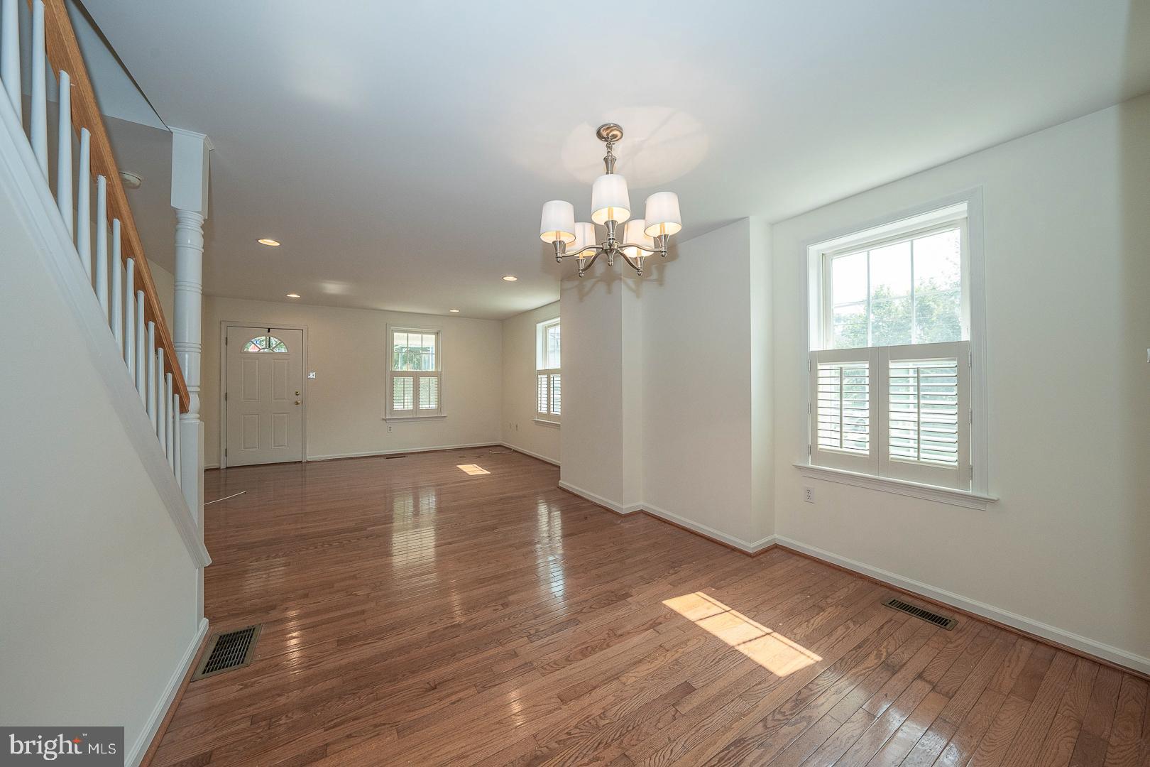 231 Plant Avenue Wayne, PA 19087 - Photo 5 of 35 an empty room with wooden floor and windows
