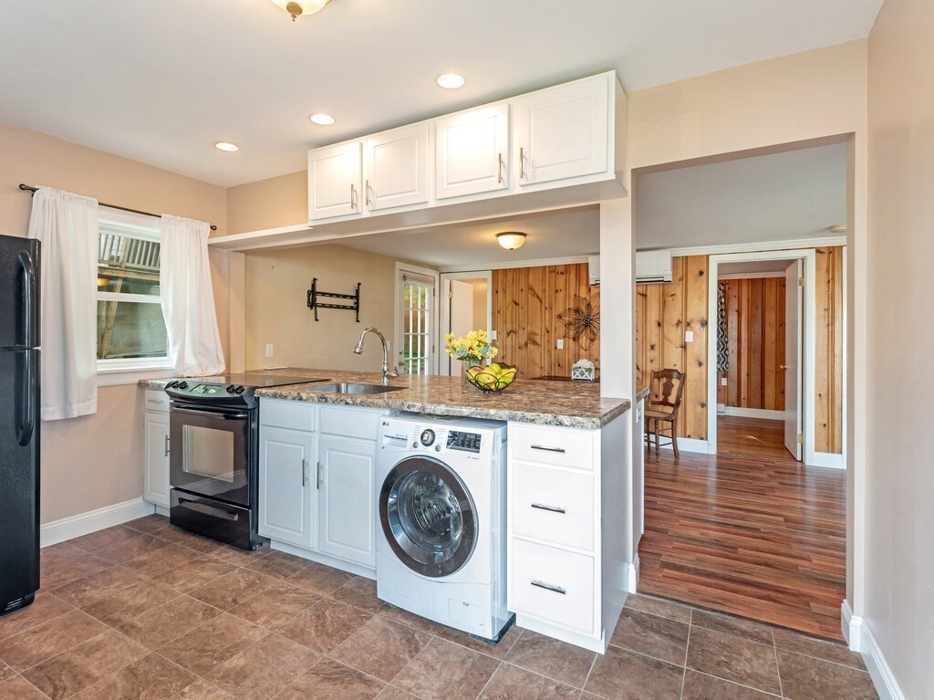 10 Hamilton Drive Holland, MA 01521 - Photo 6 of 40 a kitchen with kitchen island granite countertop a stove and a sink
