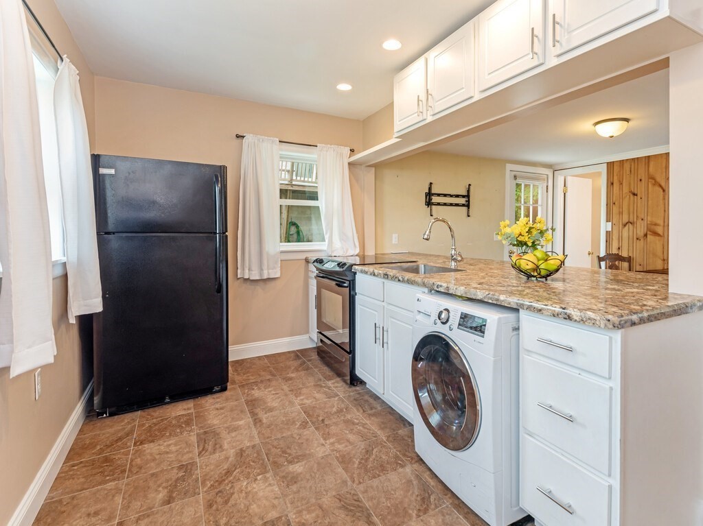10 Hamilton Drive Holland, MA 01521 - Photo 7 of 40 a kitchen with a refrigerator and a sink