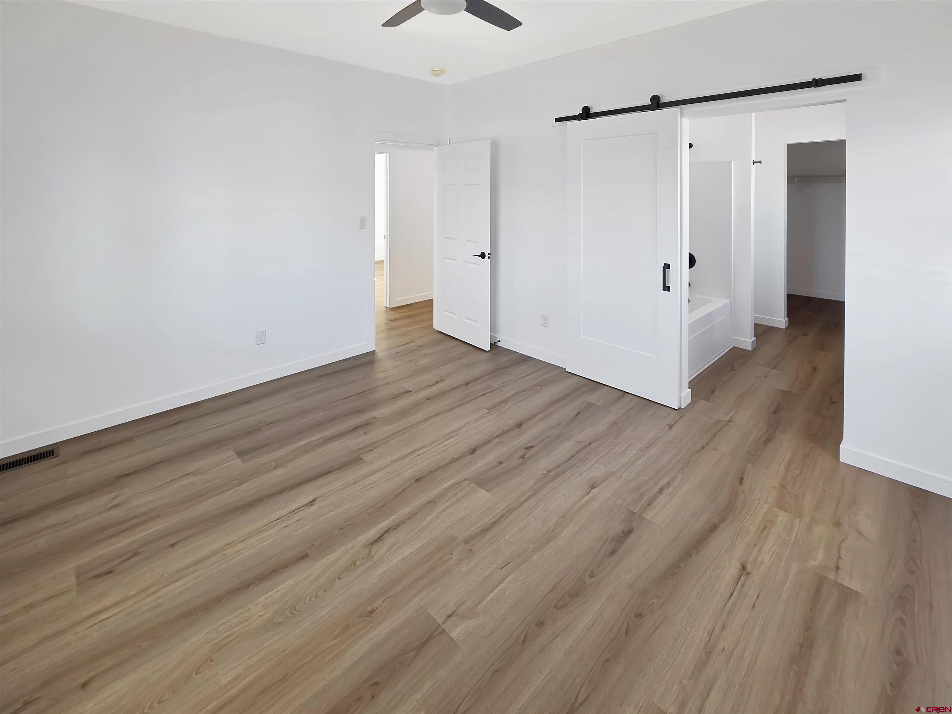 1456 Acoma Street Cortez, CO 81321 - Photo 11 of 26 a view of an empty room with wooden floor