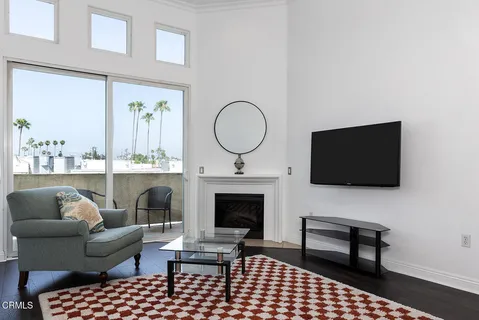 a living room with furniture a rug and a fireplace