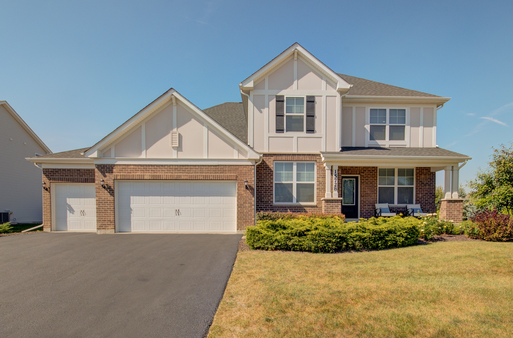 a front view of a house with a yard and garage