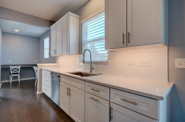 a kitchen with a sink and cabinets