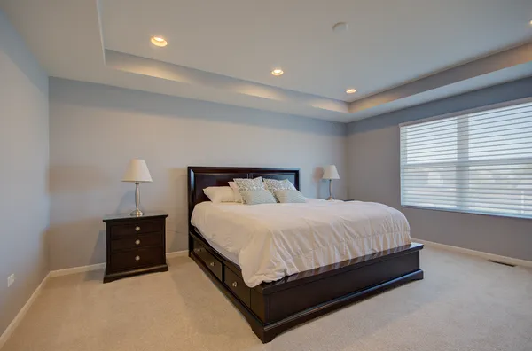 a bedroom with a bed and a night stand