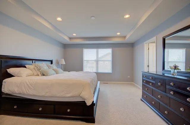 a bedroom with a bed and a dresser