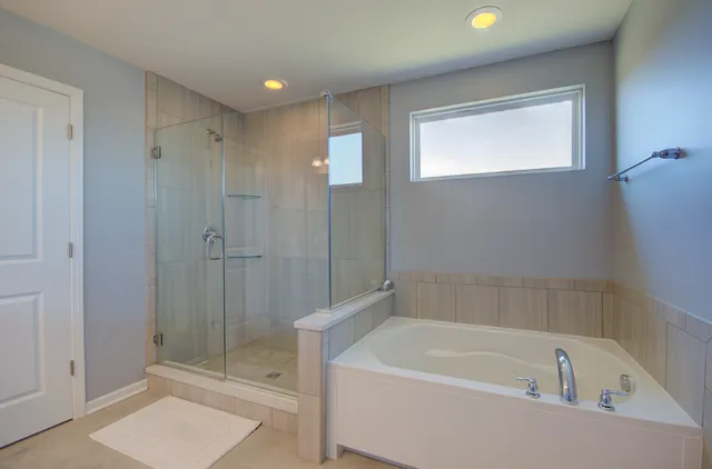 a bathroom with a bathtub and a shower