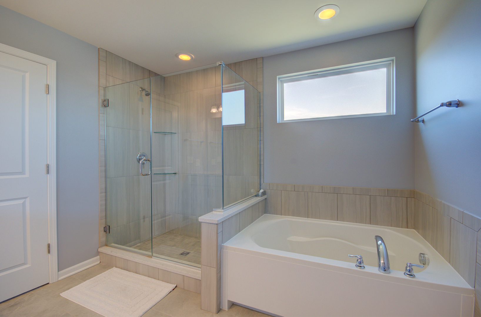 15728 Brook Shore Drive Plainfield, IL 60544 - Photo 23 of 36 a bathroom with a bathtub and a shower