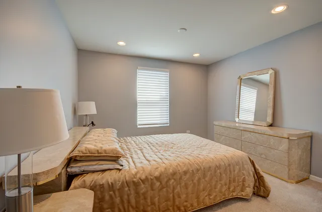 a bedroom with a bed and with a couch