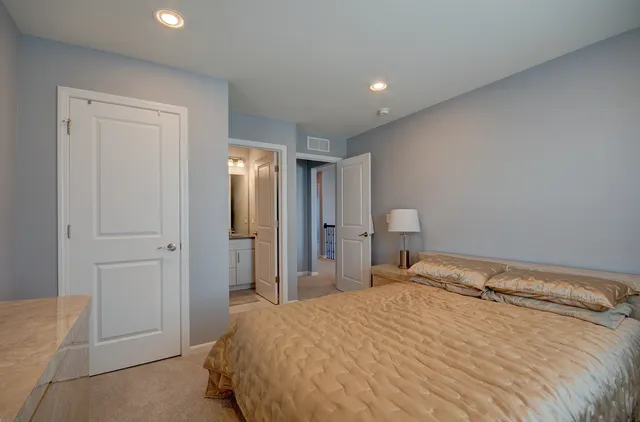 a bedroom with a bed and a lamp