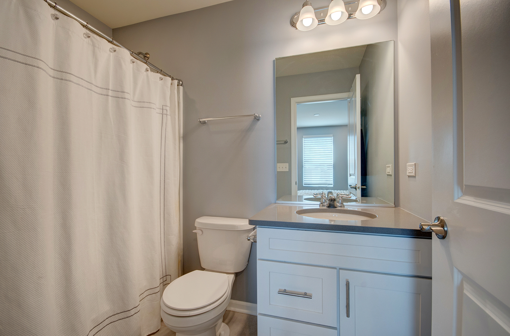 15728 Brook Shore Drive Plainfield, IL 60544 - Photo 27 of 36 a bathroom with a sink a toilet and a mirror