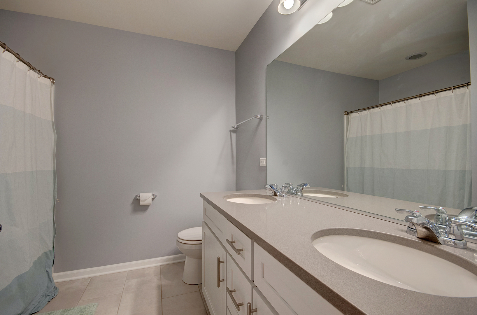 15728 Brook Shore Drive Plainfield, IL 60544 - Photo 30 of 36 a bathroom with a sink a toilet and a mirror