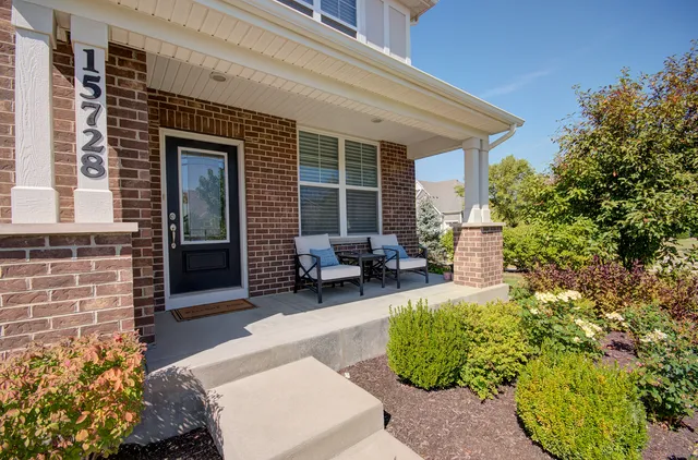 front view of a house with a chairs in patio