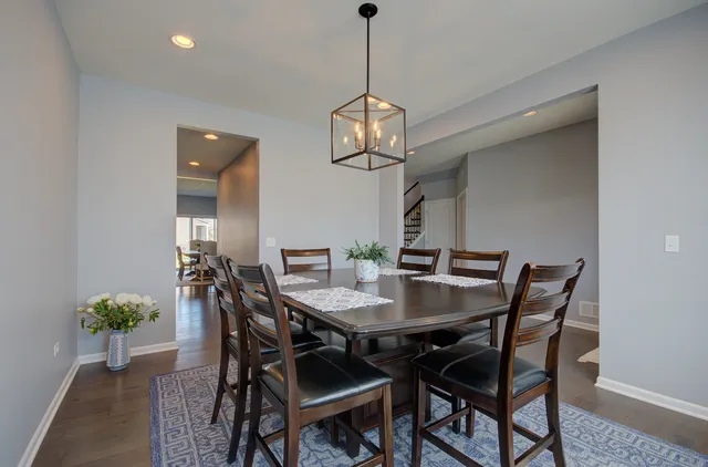 a view of a dining room with a table and chairs