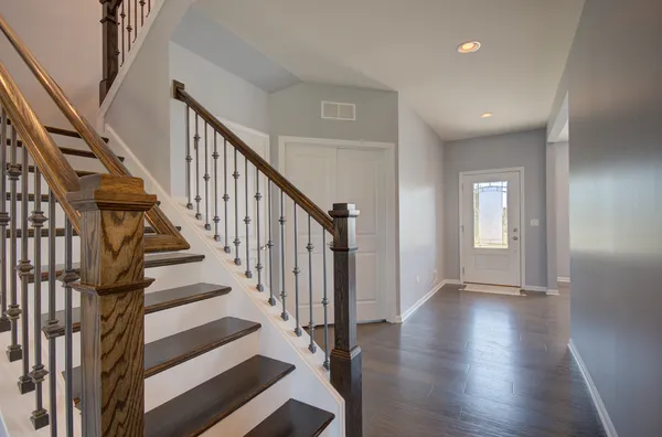 a view of staircase with wooden floor and white walls