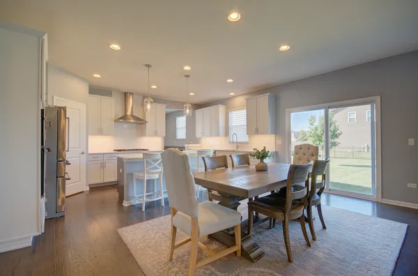 a dining room with furniture and wooden floor