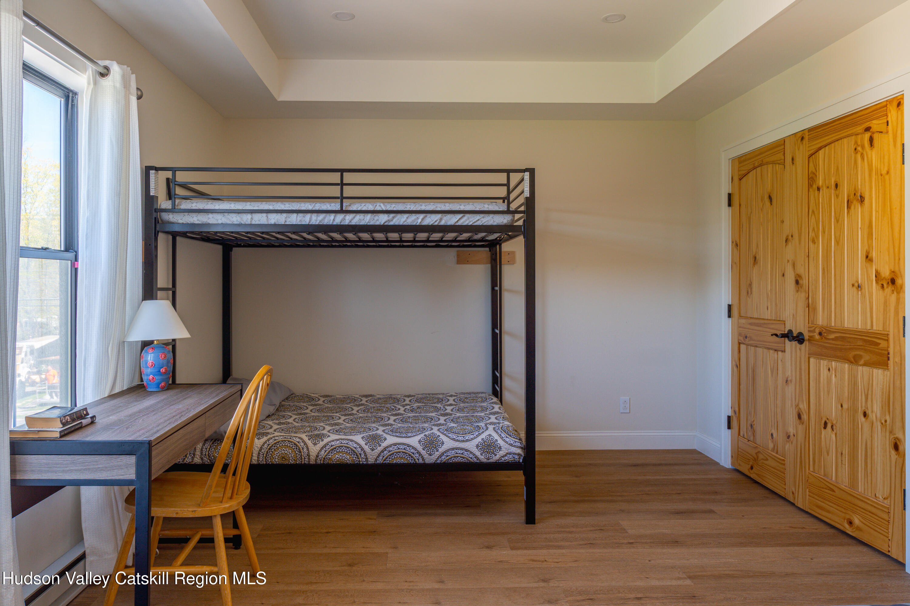 71 County Road 65, Unit 4 Windham, NY 12439 - Photo 18 of 33 a bedroom with a bed and wooden floor