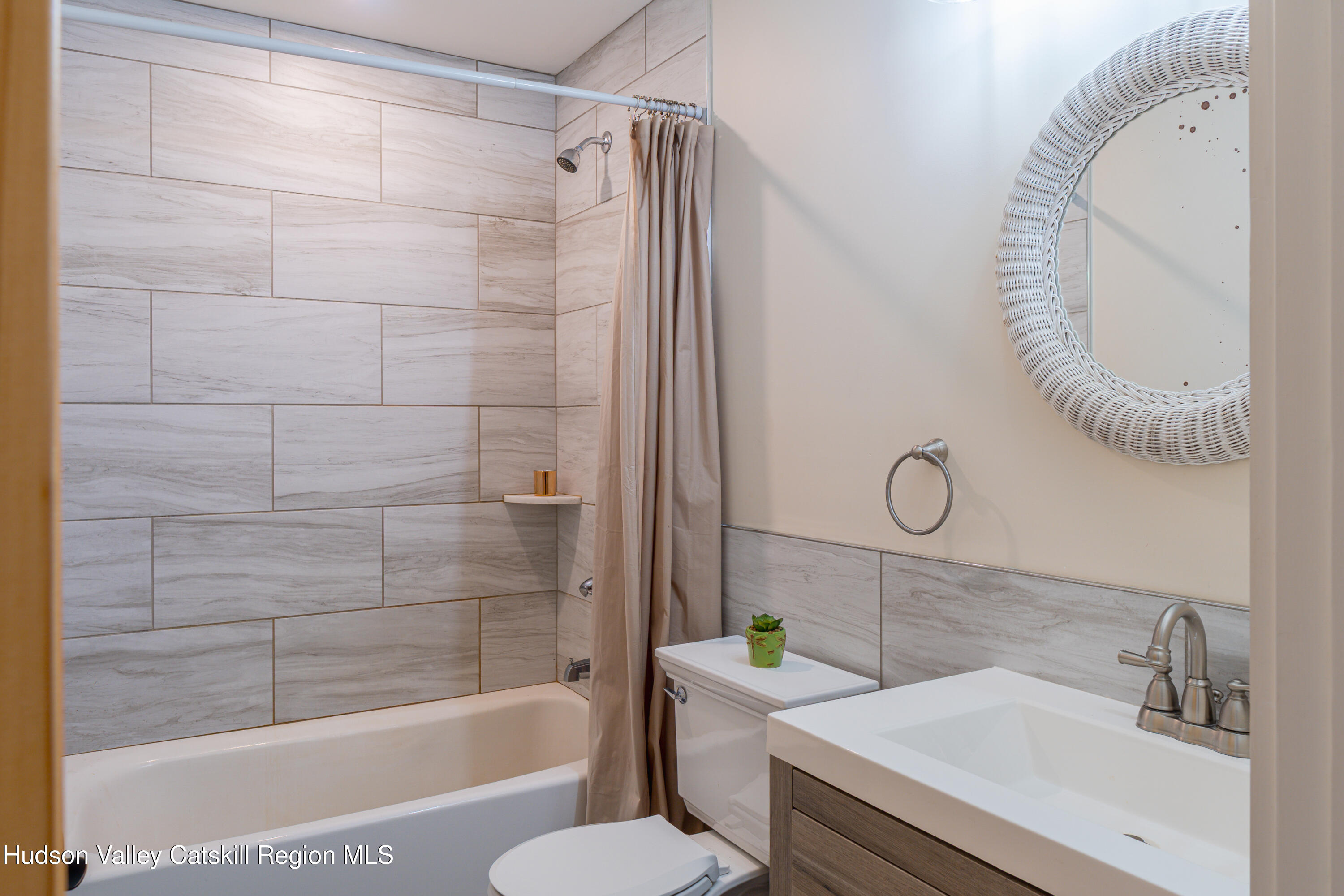 71 County Road 65, Unit 4 Windham, NY 12439 - Photo 24 of 33 a bathroom with a granite countertop sink a toilet and shower
