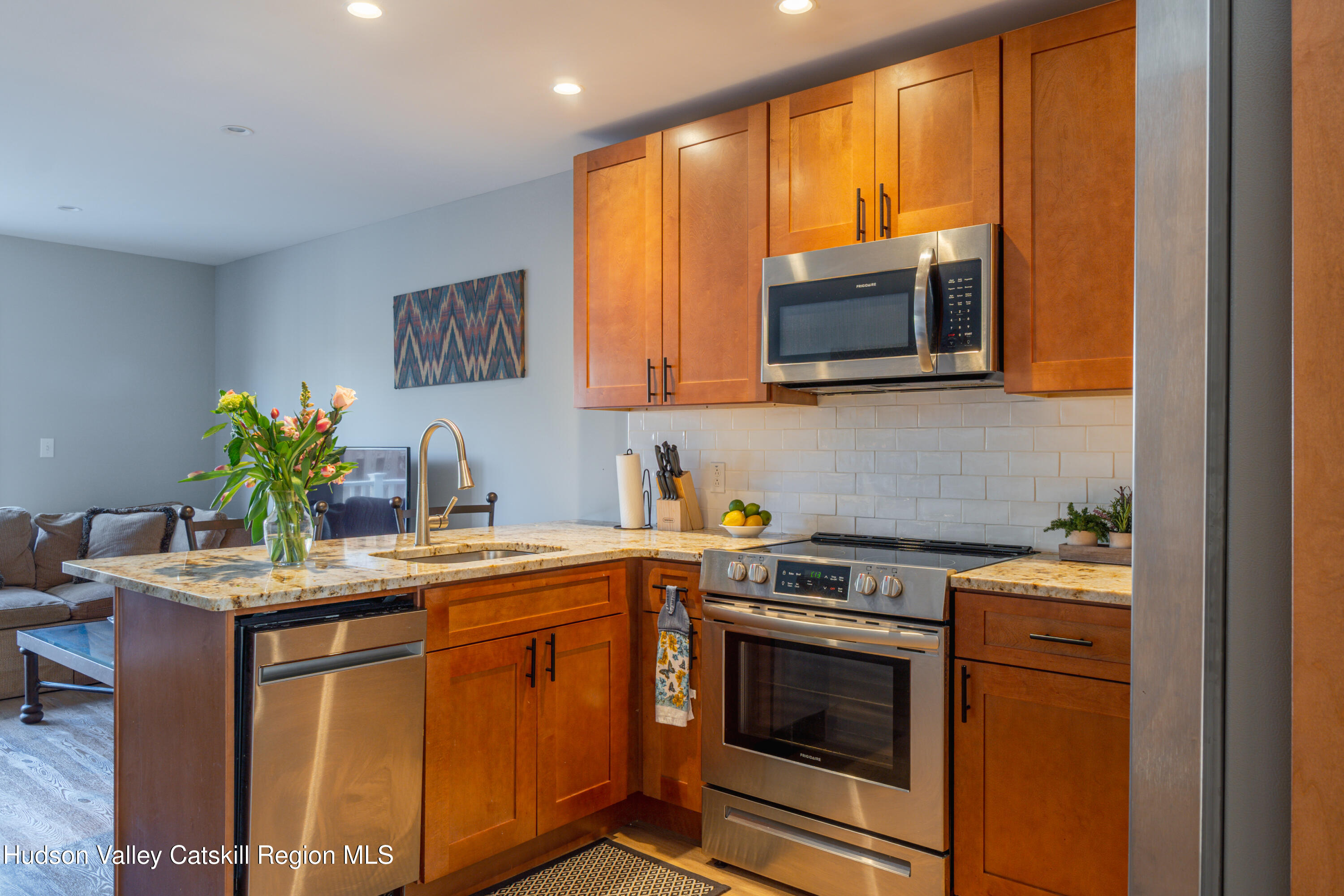 71 County Road 65, Unit 4 Windham, NY 12439 - Photo 3 of 33 a kitchen with stainless steel appliances granite countertop a sink stove and microwave