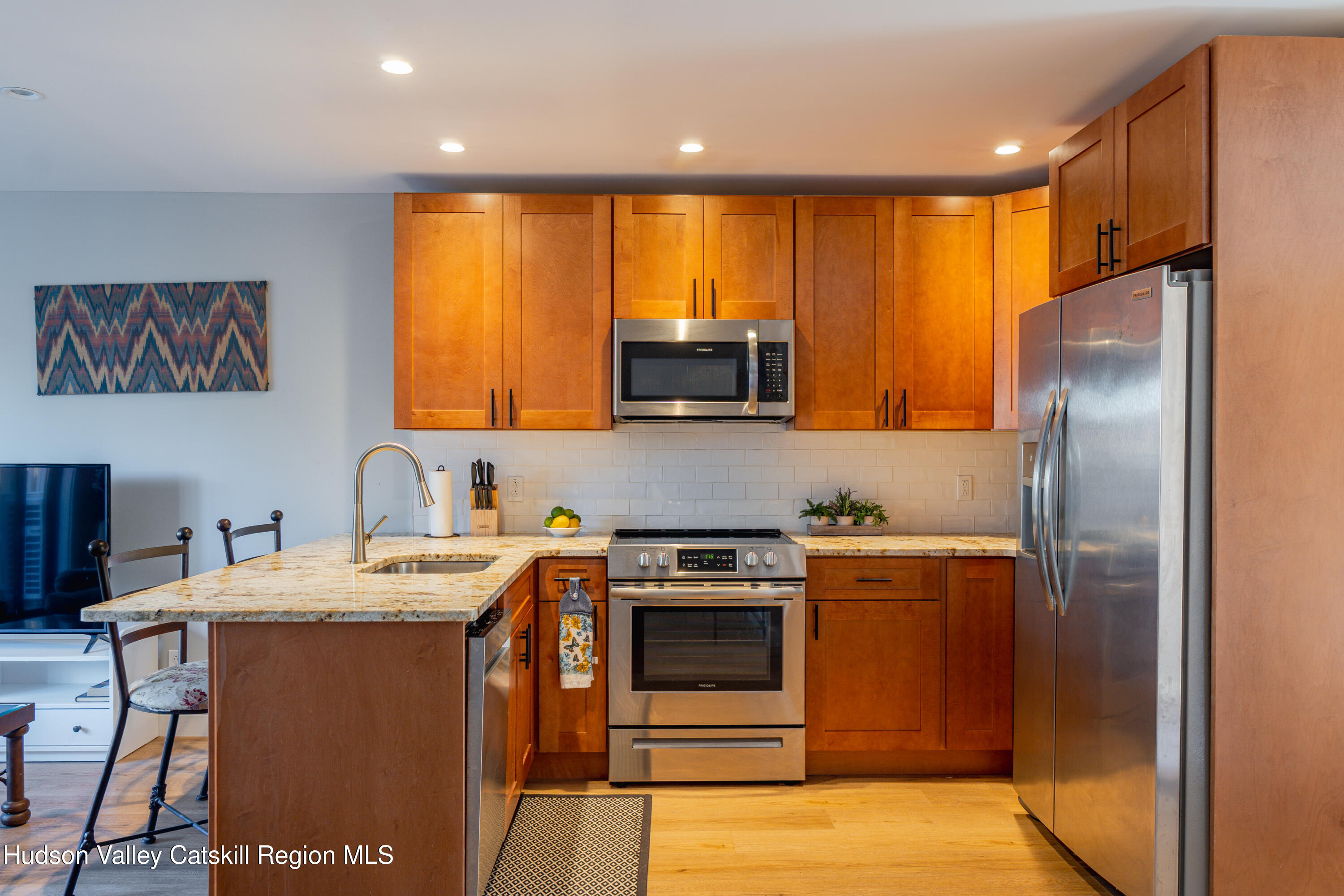 71 County Road 65, Unit 4 Windham, NY 12439 - Photo 5 of 33 a kitchen with stainless steel appliances granite countertop a refrigerator a stove a sink and a microwave