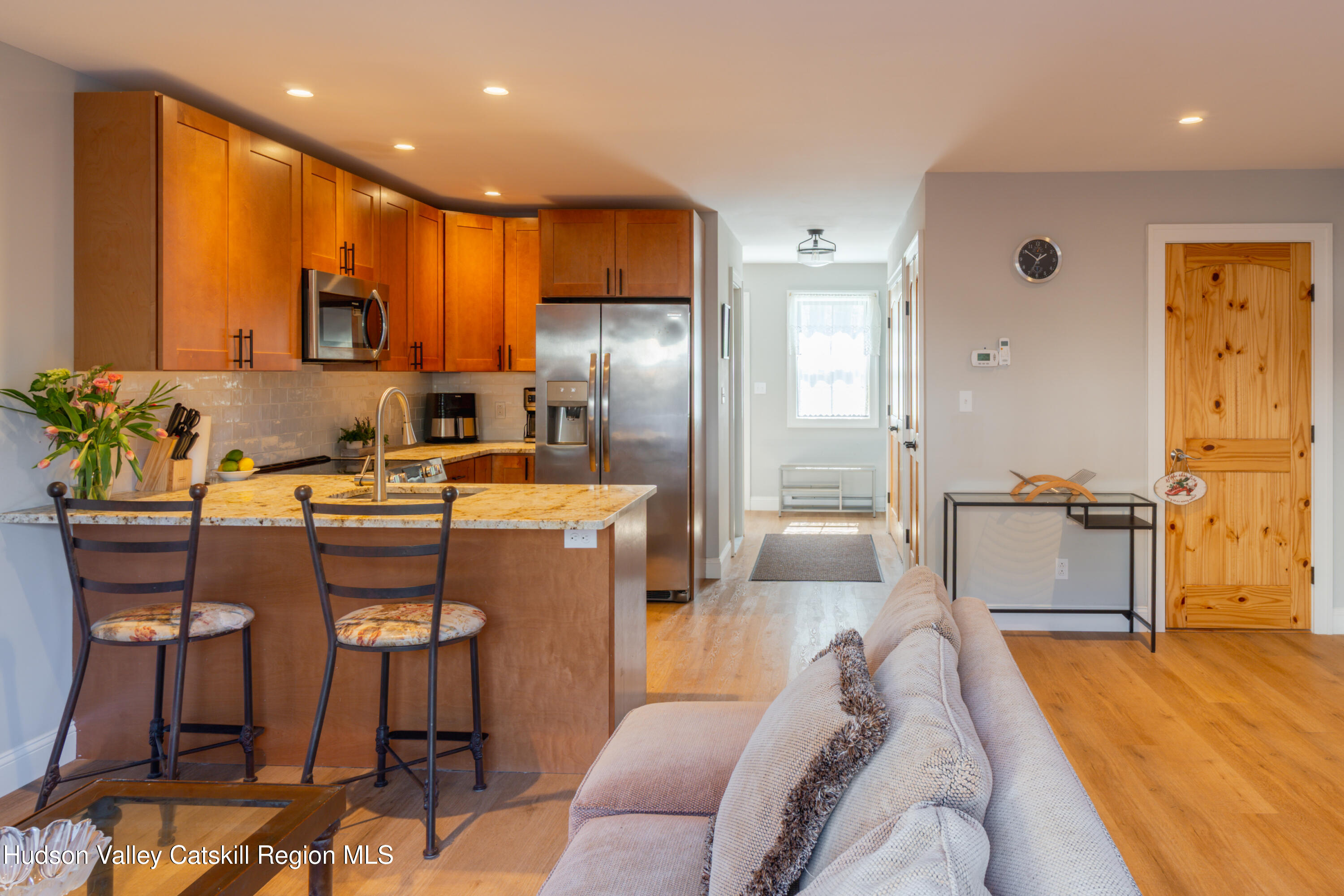 71 County Road 65, Unit 4 Windham, NY 12439 - Photo 7 of 33 a living room with stainless steel appliances kitchen island granite countertop furniture and a wooden floor