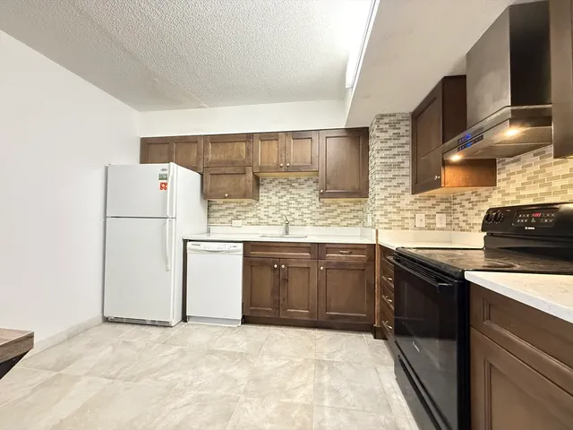 a kitchen with a sink stove and refrigerator