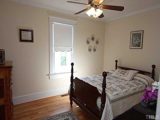 103 Georgetown Road Raleigh, NC 27608 - Photo 8 of 12 One of the four bedrooms is a quiet and inviting guest room. Bedroom