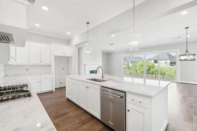 a kitchen with a sink stove and cabinets