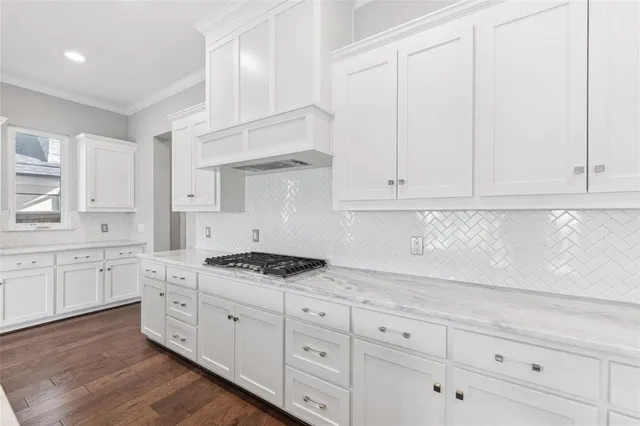 a kitchen with granite countertop white cabinets and white appliances