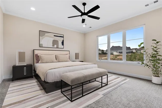 a bedroom with a large bed and a window