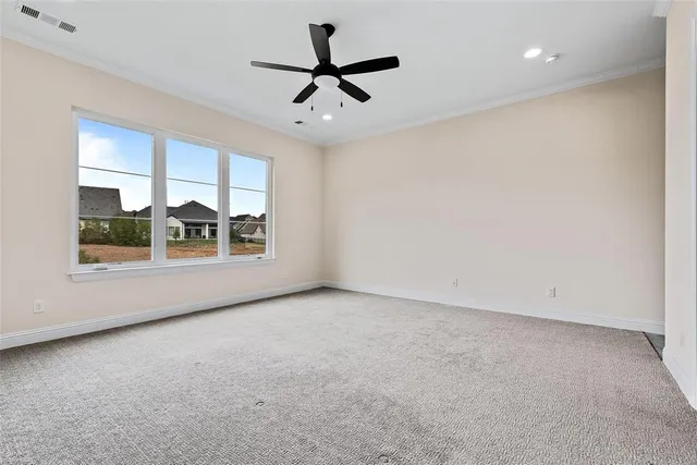 an empty room with windows and ceiling fan