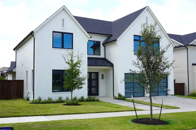 a view of a house with a yard and plants