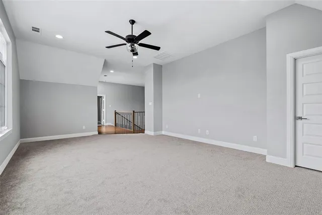 a view of a livingroom with a ceiling fan and window