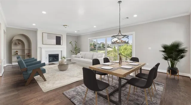 a living room with furniture a dining table and a fireplace