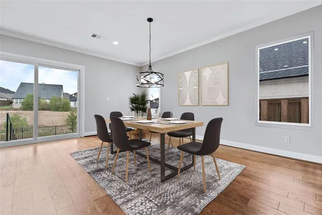 a view of a dining room with furniture window and wooden floor