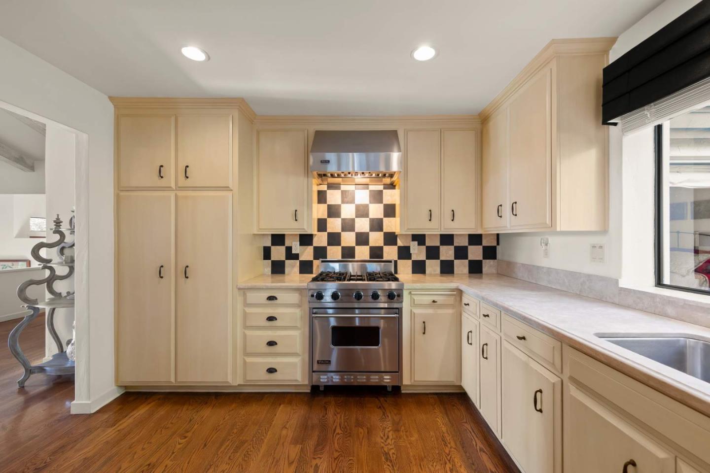 3041 Strawberry Hill Road Pebble Beach, CA 93953 - Photo 11 of 31 a kitchen with stainless steel appliances a stove and white cabinets
