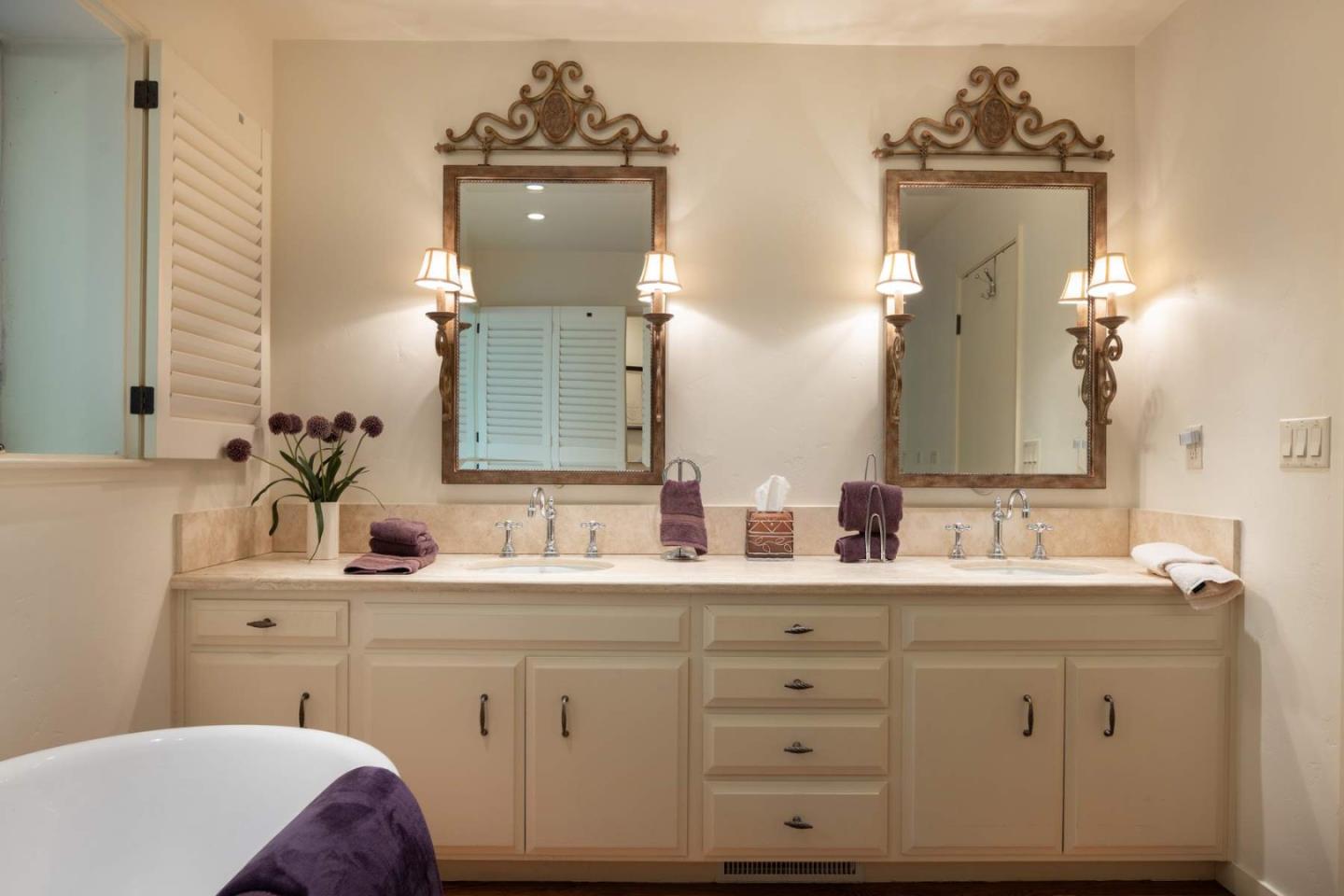 3041 Strawberry Hill Road Pebble Beach, CA 93953 - Photo 18 of 31 a bathroom with a double vanity sink and mirror
