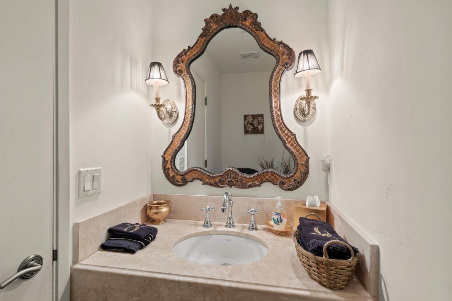 3041 Strawberry Hill Road Pebble Beach, CA 93953 - Photo 25 of 31 a bathroom with a sink and a mirror