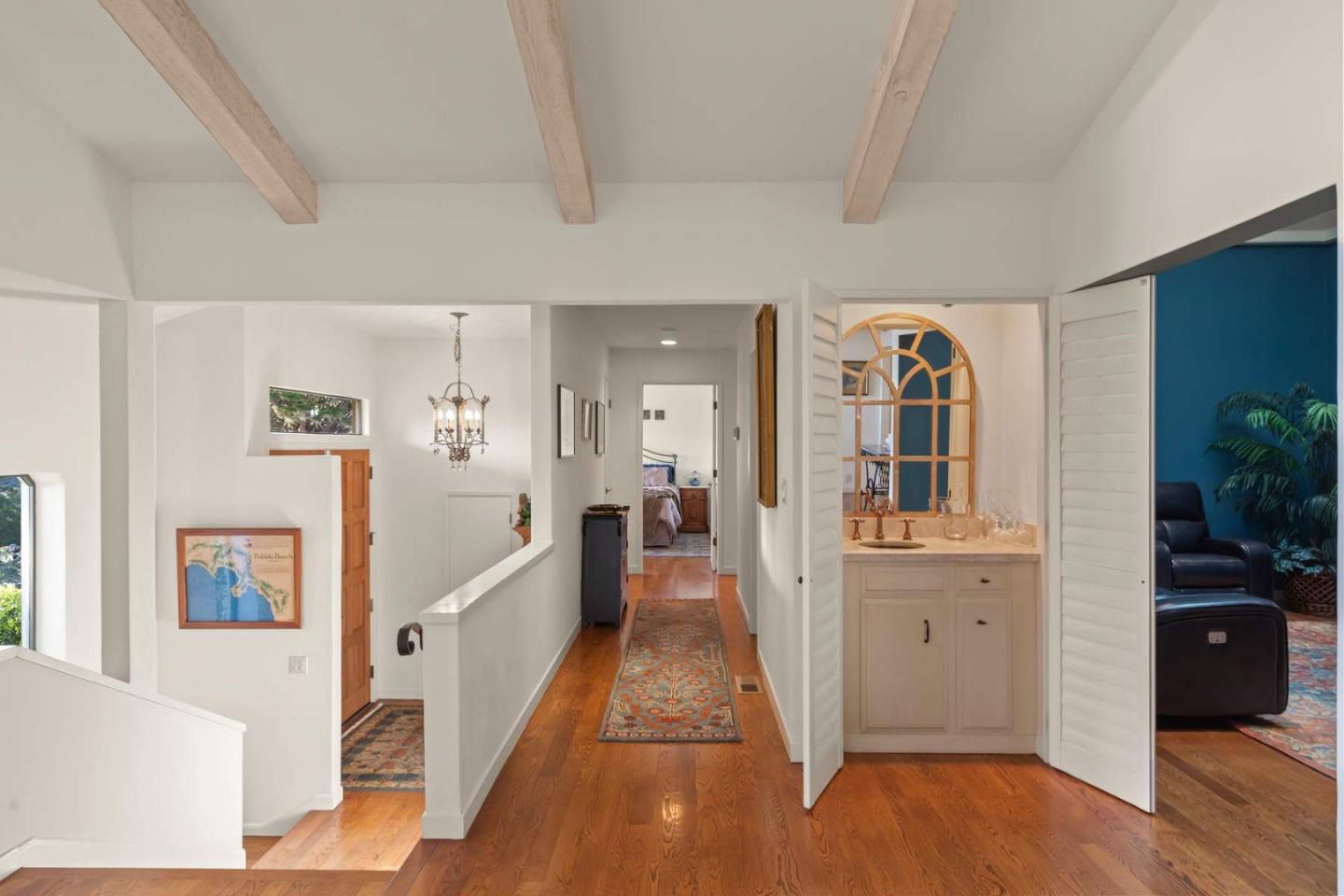3041 Strawberry Hill Road Pebble Beach, CA 93953 - Photo 7 of 31 a large white kitchen with cabinets and wooden floor