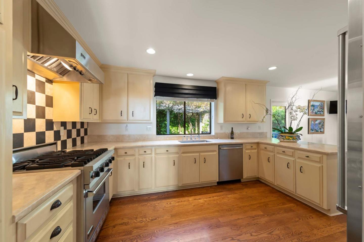 3041 Strawberry Hill Road Pebble Beach, CA 93953 - Photo 9 of 31 a kitchen with a sink stove and cabinets