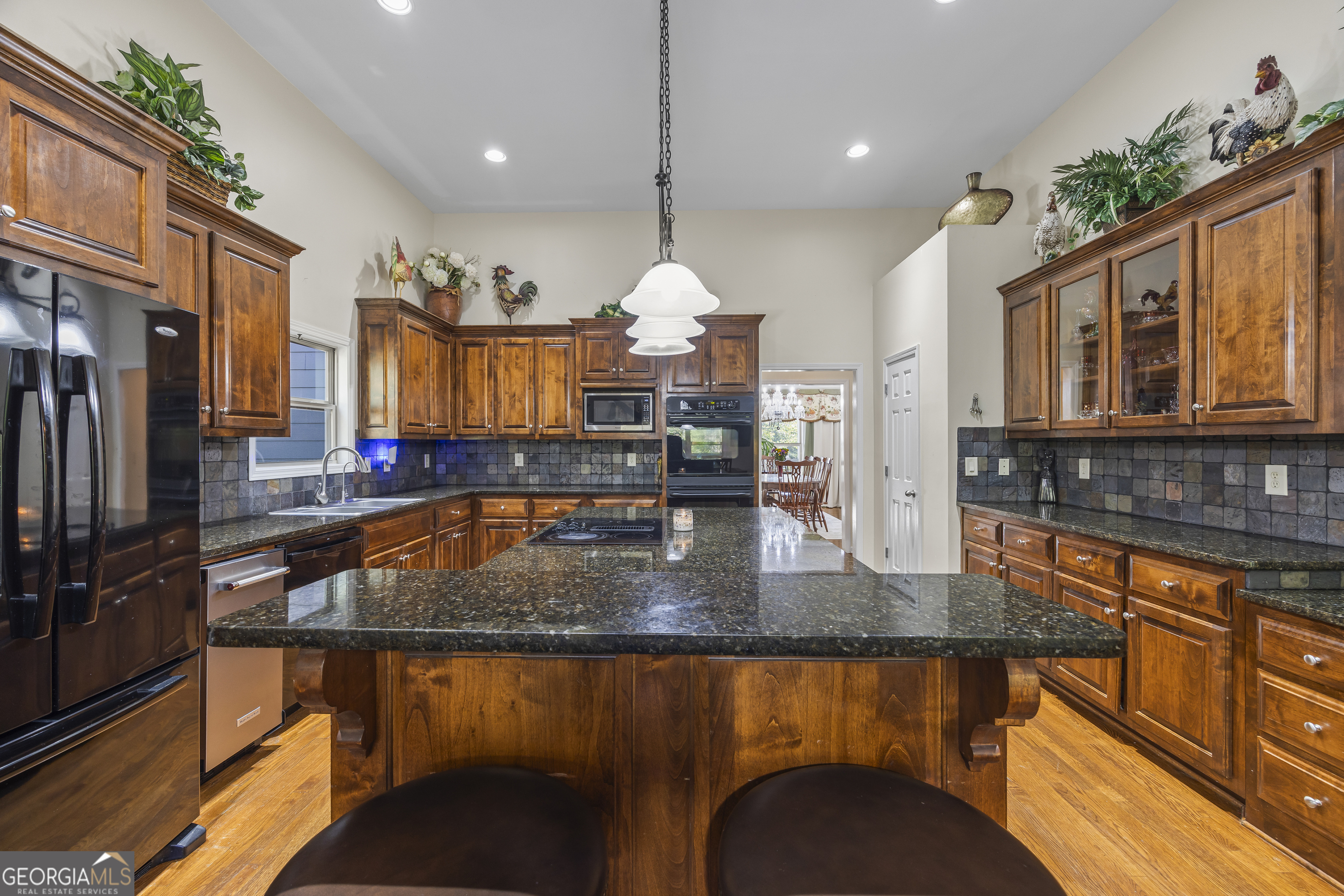 135 Canters Run Homer, GA 30547 - Photo 22 of 96 a kitchen with stainless steel appliances granite countertop a sink a stove and a wooden cabinets
