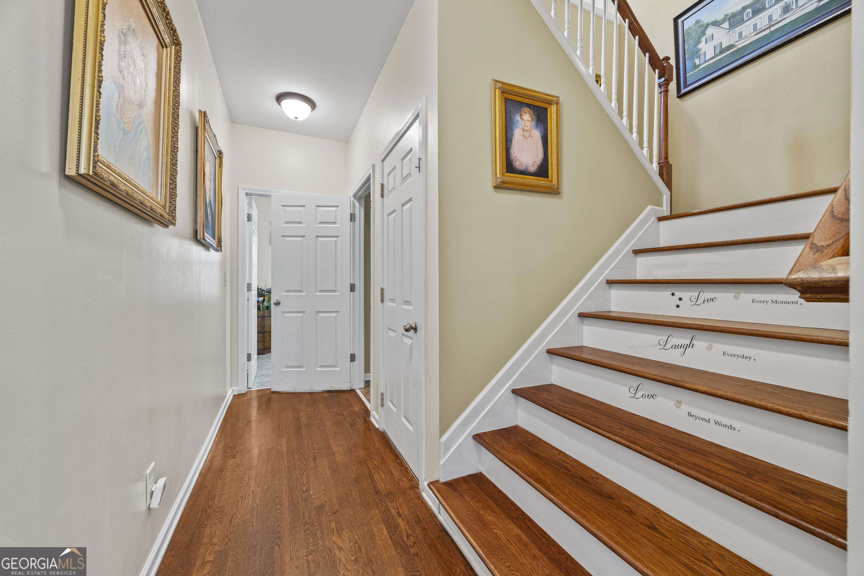 135 Canters Run Homer, GA 30547 - Photo 56 of 96 a view of a hallway with wooden floor and staircase