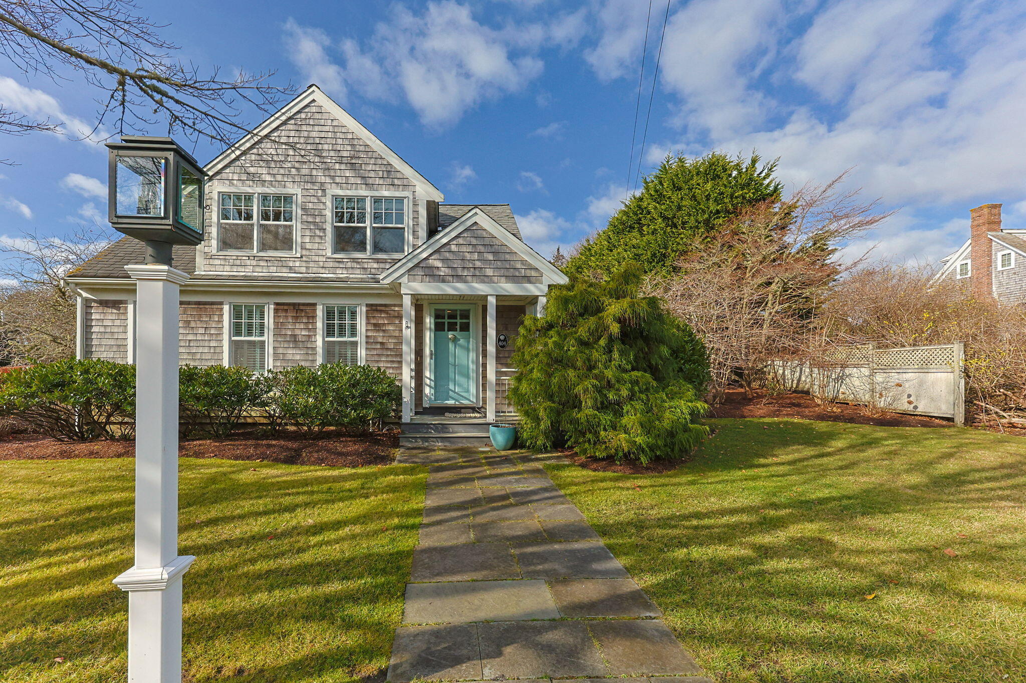 404 Stage Harbor Road Chatham, MA 02633 - Photo 2 of 94 a front view of a house with a yard