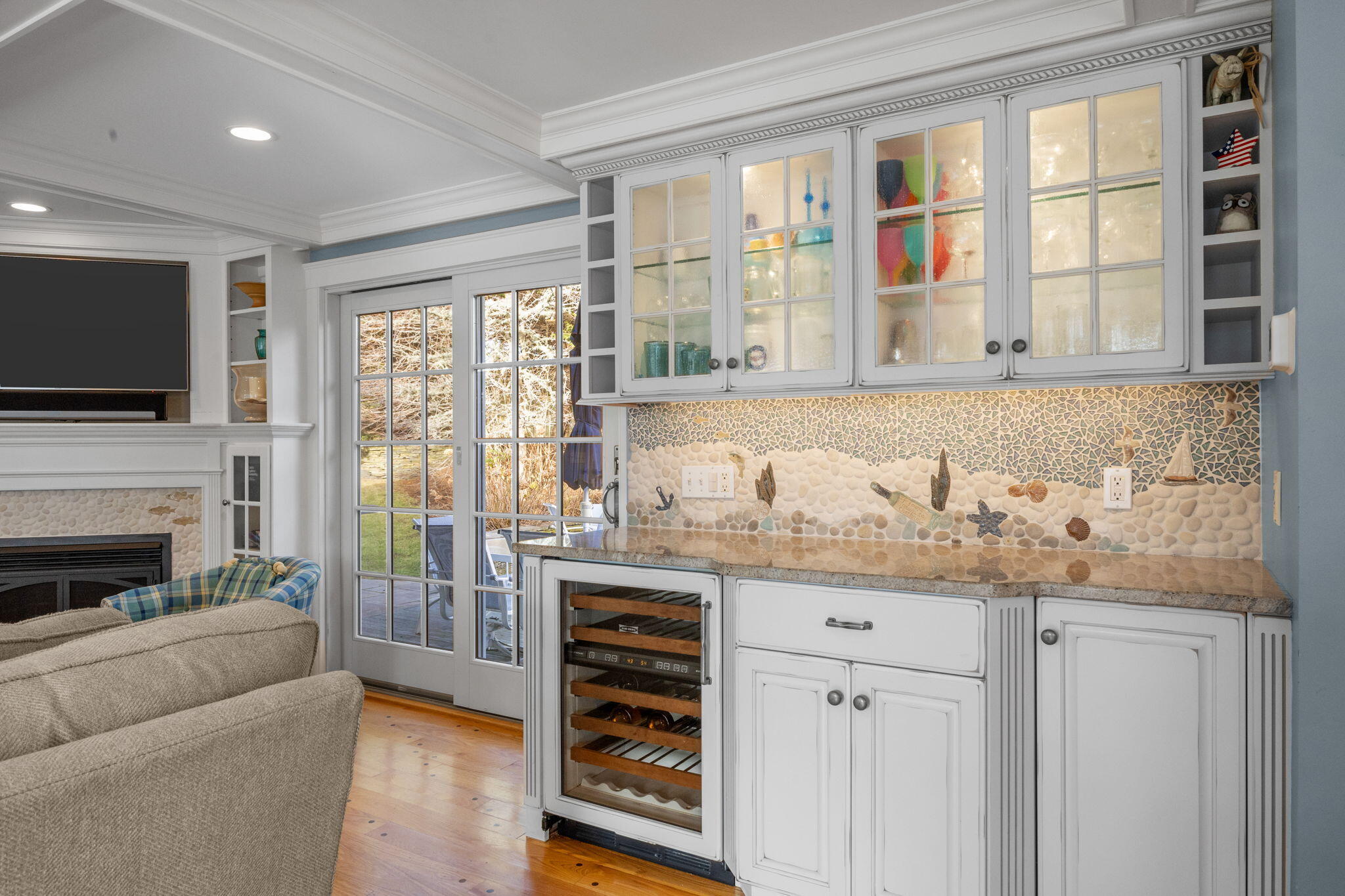 404 Stage Harbor Road Chatham, MA 02633 - Photo 31 of 94 a living room with furniture a flat screen tv and a floor to ceiling window