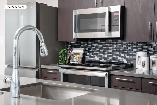 a kitchen with granite countertop a stove and a microwave