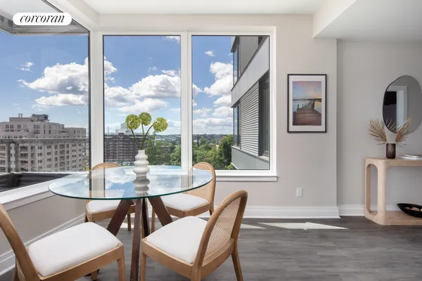 a view of a dining room with furniture a chandelier and wooden floor