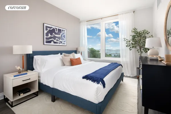 a bedroom with bed and a potted plant