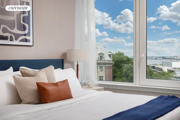 a bed sitting in a bedroom next to a window