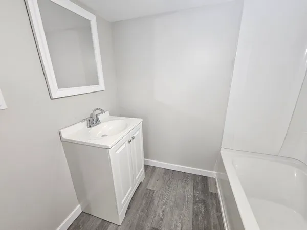 a utility room with a sink a mirror and vanity