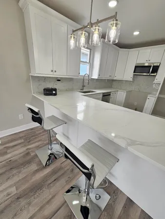 a kitchen with a sink stainless steel appliances and cabinets